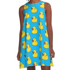 a girl wearing a blue dress with yellow rubber ducks on the front and back, all over