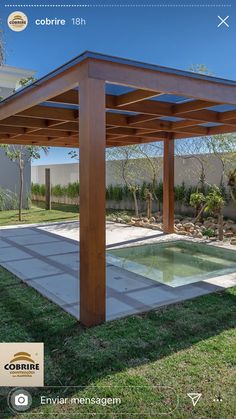 a wooden pergolan in the middle of a yard next to a swimming pool