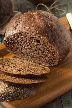 a loaf of bread sitting on top of a wooden cutting board