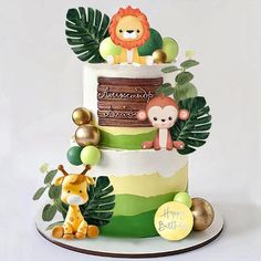 a three tiered cake decorated with jungle animals