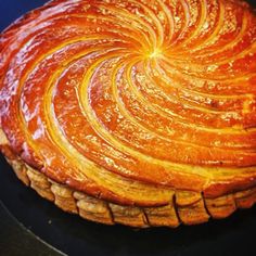 a large pastry is sitting on a black plate