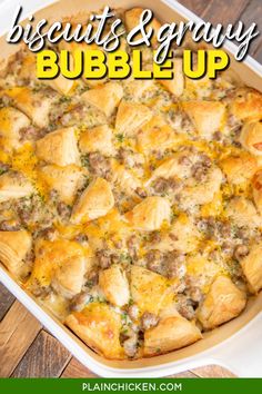 a casserole dish with biscuits and gravy in it on a wooden table