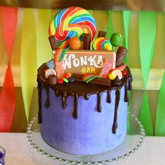 there is a birthday cake decorated with candies and lollipops