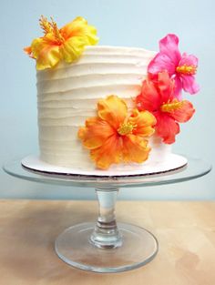 a white cake with orange and yellow flowers on top