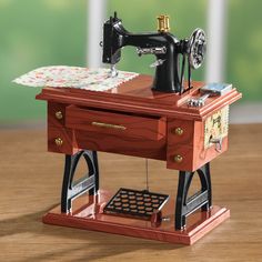 a toy sewing machine sitting on top of a wooden table