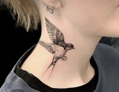 a woman with a bird tattoo on her neck