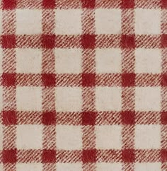 a red and white checkered fabric is shown in close up view on the surface