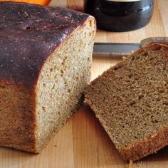 a loaf of bread sitting on top of a wooden cutting board next to a knife