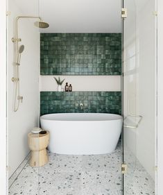 a white bath tub sitting next to a walk in shower