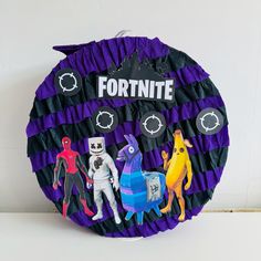 a purple and black paper plate topped with pictures of people in different costumes on it