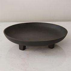 a black bowl sitting on top of a white counter