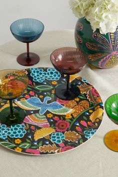 colorful glass dishes and vases on a table