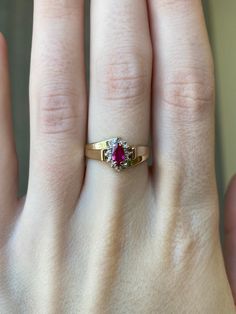 a woman's hand with a yellow and red ring on top of her finger