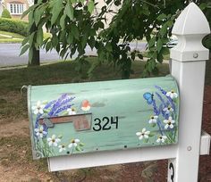 a mailbox with flowers painted on it