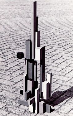 an abstract sculpture on the ground in black and white