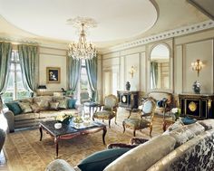 a living room filled with furniture and a chandelier