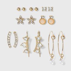 Glam up any outfit with the intricate detail of the Charm Hoop, Stud and Ear Climber Earring Set from A New Day™. This set includes four pairs of studs, two pairs of bejeweled ear climbers and one pair of wire hoop earrings with charms, all in a highly polished yellow gold-tone finish. Each post earring comes complete with a bullet-clutch back for secure wear, while climbers and hoops are designed to stay in place without extra backs. Wear pairs separately for a simple, minimalist jewelry look, Earring Pack, Wire Hoop Earrings, Stone Drop Earrings, Target Gifts, Ear Climbers Earrings, Ear Climber, Ear Climbers, Dainty Studs, Climber Earrings