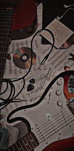 an electric guitar is surrounded by music sheets