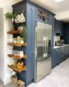 a kitchen with blue cabinets and shelves filled with food