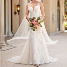 a woman in a wedding dress is standing outside