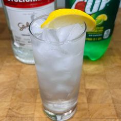 a glass filled with ice and a lemon wedge