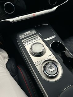 the center console of a car with an automatic gear box and control knobs on it