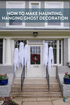 the front door of a house decorated for halloween with white ghost decorations and wreaths