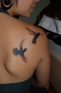 a woman with a bird tattoo on her back