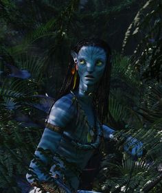 a woman dressed as avatar in the jungle