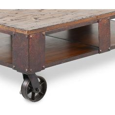 an old wooden coffee table with wheels on the bottom and two shelves in the middle