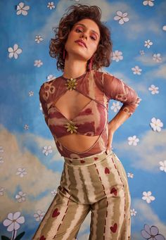 Playfully captivating, this co-ord set is crafted in multi-hued organza and features a round neckline with cutouts at the center, enhanced with floral trims and full sleeves. The top offers a contoured fit with a chic style, best paired with high-waisted straight pants for a polished and stylish look. Festive Fitted Sheer Sets, Festive Sets With Sheer Sleeves And Organza Material, Festive Organza Sets With Sheer Sleeves, Summer Party Organza Sets, Organza Party Sets With Sheer Sleeves, Sheer Spring Party Sets, Chic Festive Fitted Sets, Chic Fitted Festive Set, Party Sets With Sheer Long Sleeves