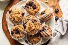 blueberry muffins on a plate with a cup of coffee