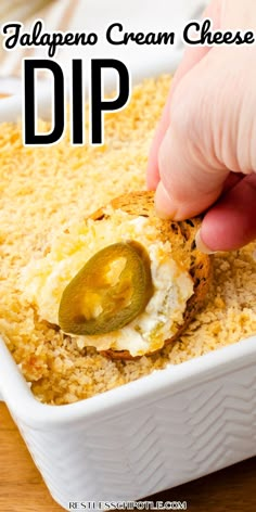 someone dipping an egg into a casserole dish with cheese and jalapeno