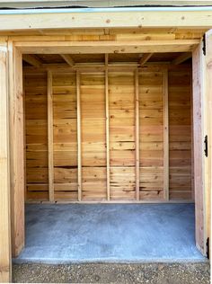 an empty wooden storage shed with no doors