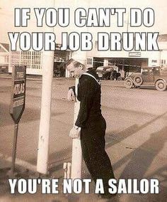 a man leaning on a pole next to a sign that says if you can't do your job drunk, you're not a sailor