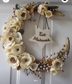 an image of a wreath with flowers on the front door and star hanging from it