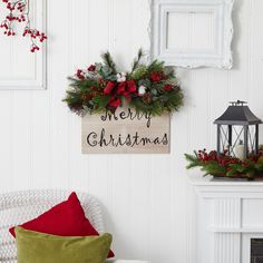 christmas decorations are hanging on the wall next to a chair and fire place in a living room