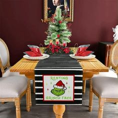 the grinch face christmas table runner is sitting on top of a wooden dining room table