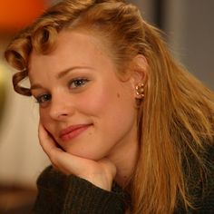 a close up of a person with long hair and wearing earrings on her head