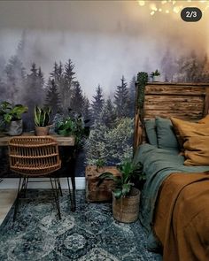 a bedroom with a bed, desk and chair in front of a forest wall mural