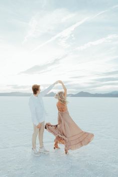 a man and woman dancing in the snow