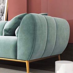 a blue couch sitting on top of a floor next to a mirror