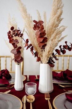 two vases filled with flowers on top of a table