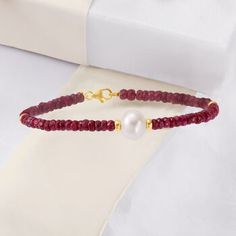 Ross-Simons - 9-10mm Cultured Pearl, 25.00ct t. w. Ruby Beaded Bracelet, 14kt Yellow Gold. 8.25". Our bracelet features fiery 25.00 ct. t. w. round faceted ruby beads that meet at the center to a luminous 9-10mm cultured freshwater pearl. Creating quite an impression, the pearl is held between 4mm 14kt yellow gold spacer beads. Due to the rough-cut nature of the beads, stone count and size may vary. Lobster clasp, white pearl and ruby bracelet. Pearl birthstones are the perfect gift for June bir Jewelry Presentation, Emerald Earrings Drop, Cultured Pearl Bracelet, Pearl Birthstone, Tanzanite Necklace, Ruby Bracelet, Ruby Beads, Yellow Gold Jewelry, Red Jewelry