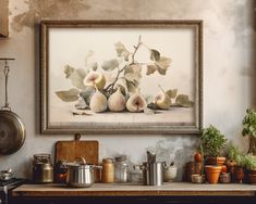 an old kitchen with pots and pans on the counter, framed by a painting