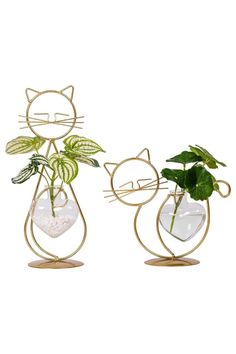 two cat shaped planters with plants in them