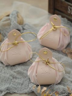 three small pink purses sitting on top of a table