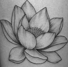 a black and white lotus tattoo on the leg