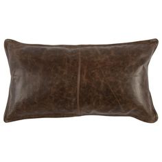 a brown leather pillow on a white background