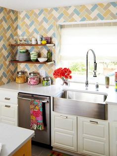 a kitchen with colorful wallpaper and stainless steel dishwasher in the center, open shelving